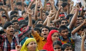 Garment workers shout slogans during a rally demanding an increase to their minimum wage in Dhaka