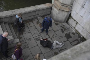 A man lies injured after a shottingt incident on Westminster Bridge in London